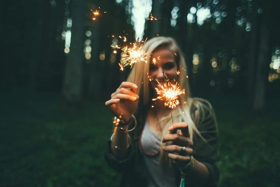 This blonde woman with sparklers in the forest is all about contentment... also fire safety