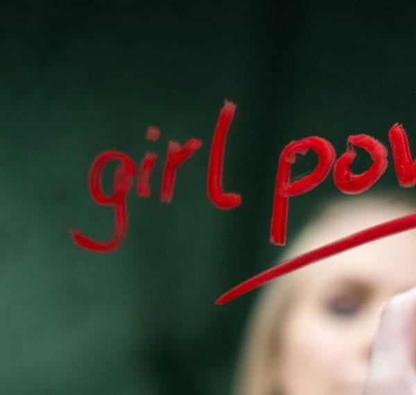 woman writing girl on mirror with red lipstick