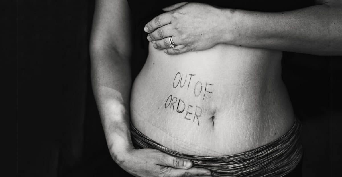 woman holding her belly saying out of order