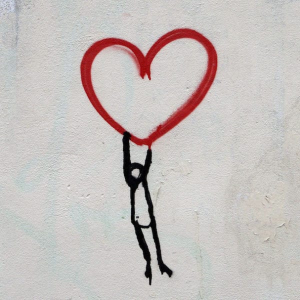 line man hanging off a heart