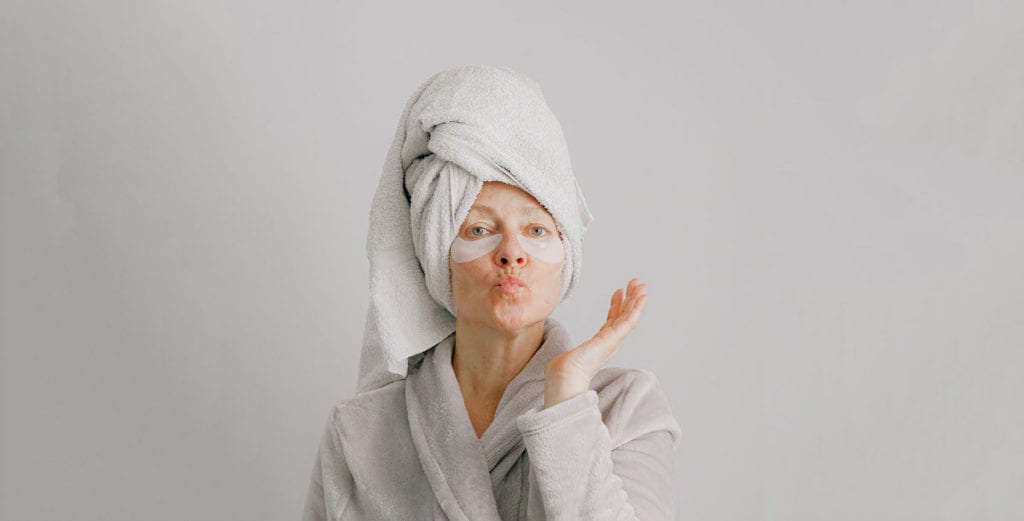woman in dressing gown, towel turban and eye mask