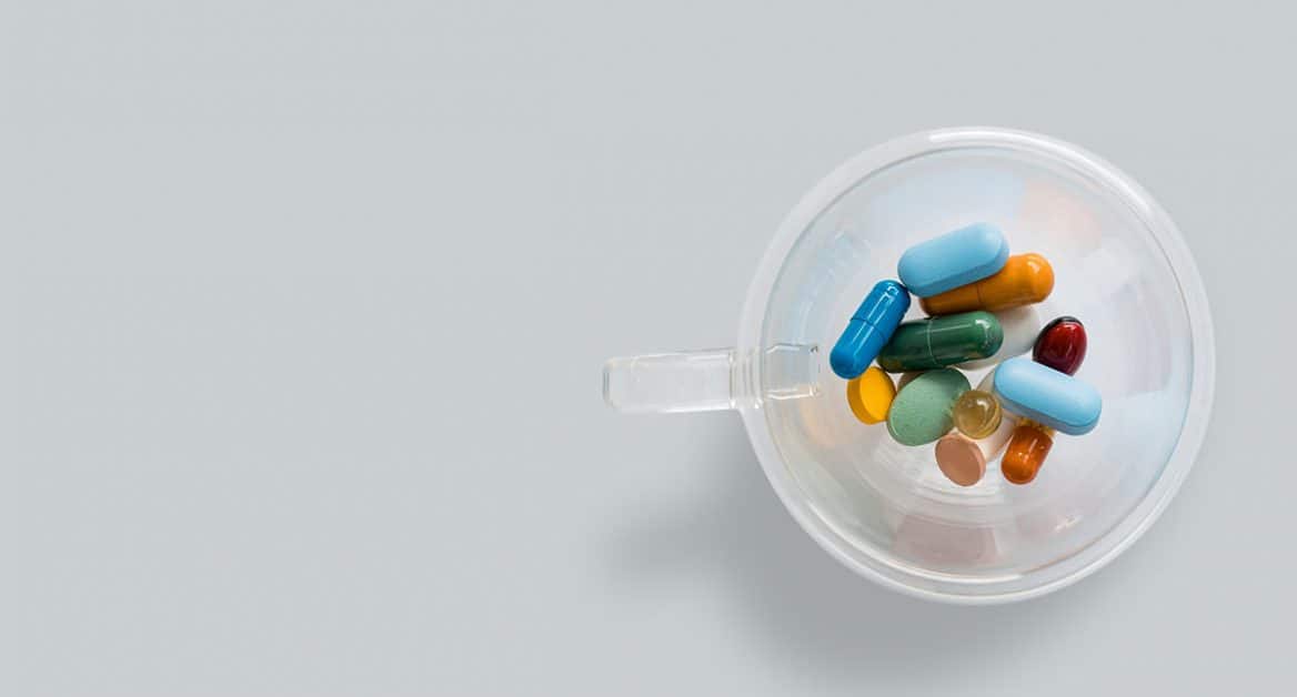 colourful pills in a cup