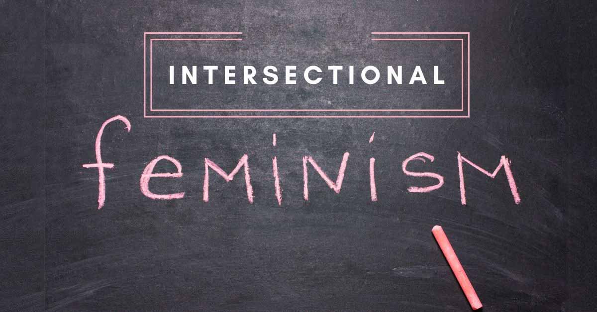 intersectional feminism in pink on blackboard