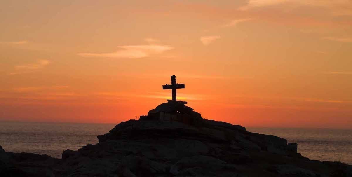 cross on a hill in sunset