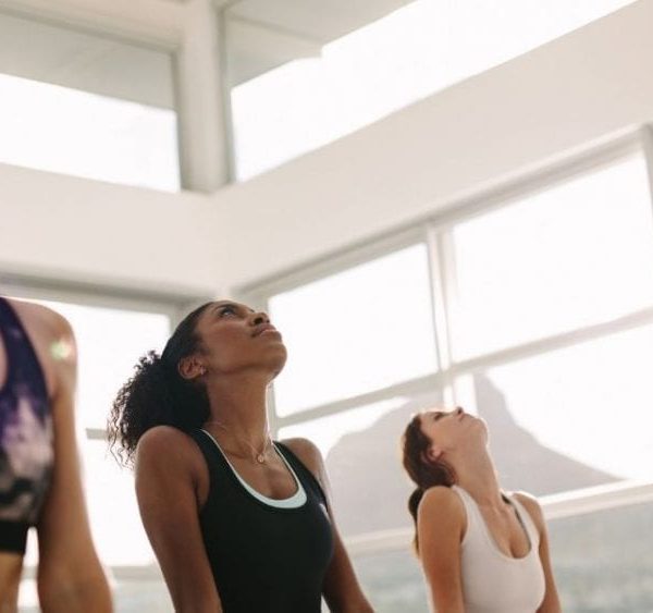 three women doing yoga