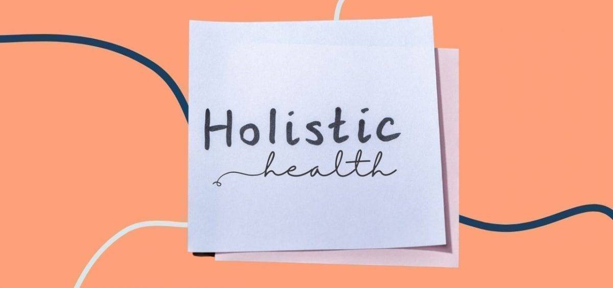 holistic health on post it note on orange background