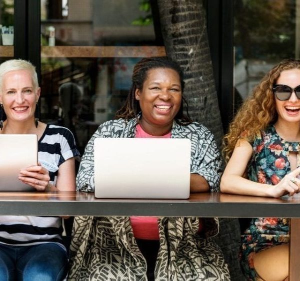 women of different ethnicities sitting together in a row