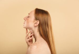 woman touching her chin and throath