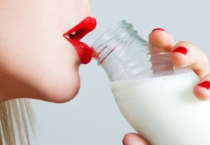 woman with red lips drinking milk
