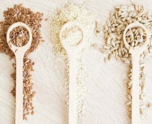 mix of seeds on wooden spoons