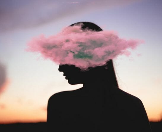 woman in profile with head in the clouds