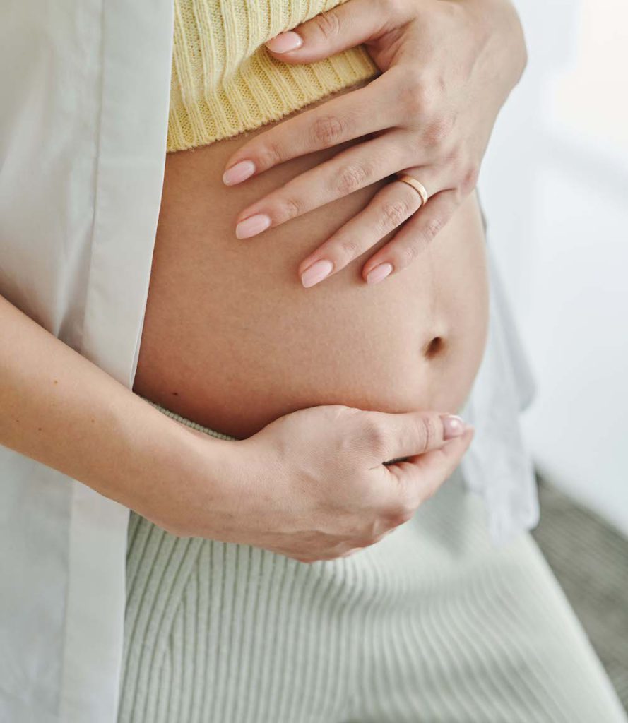 woman holding her baby bump