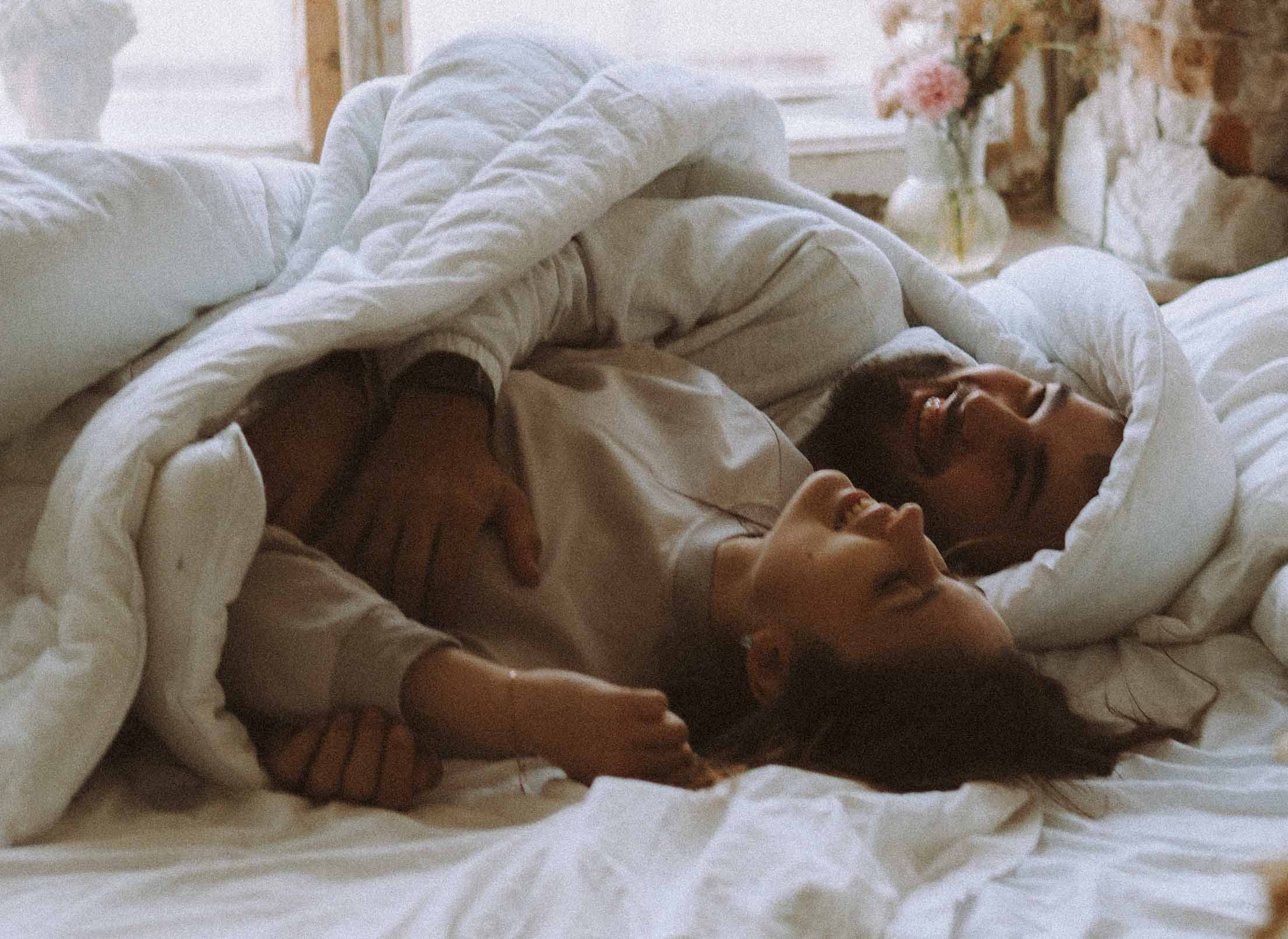 embrace your sexuality like this couple cuddling in bed