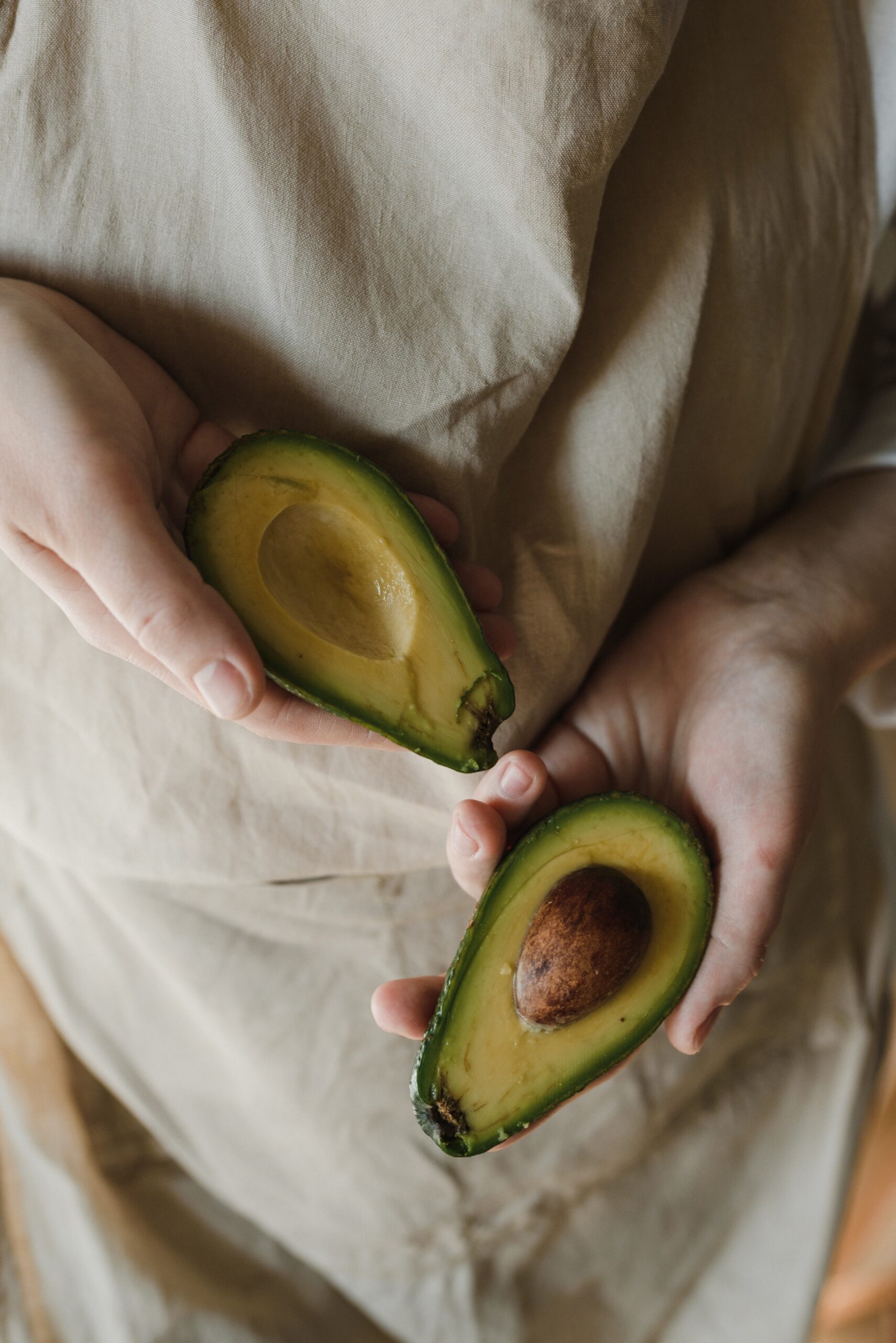 women with sliced avocado